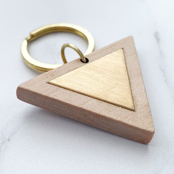 Pale white wood triangle key ring with brass metal inlay