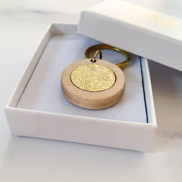 Pale white wood round key ring with brass inlay, displayed in Vannucchi Jewellery branded box