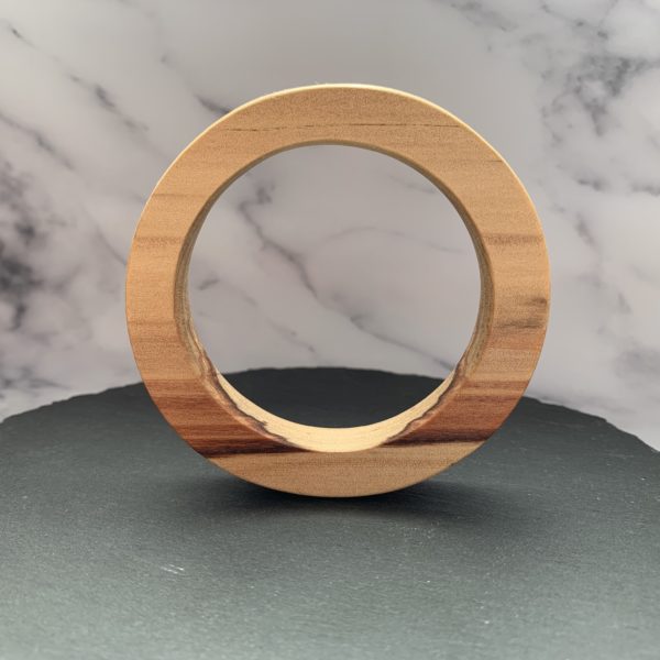 Vannucchi Jewellery's Sara parana pine bangle stood upright on slate