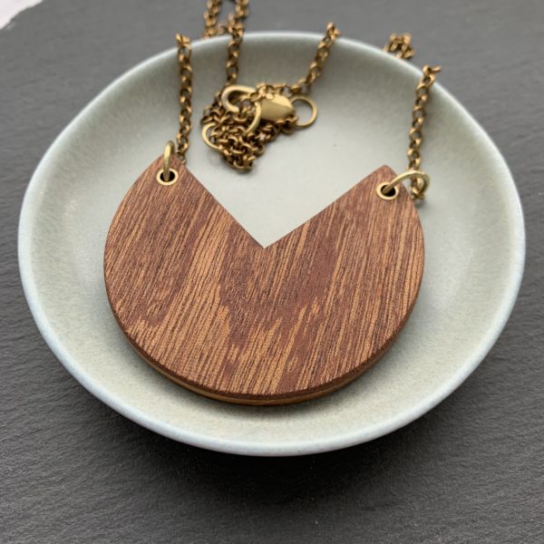 Fiona wood laminate necklace displayed in aqua coloured dish