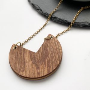 Fiona wood laminate necklace draped over slate