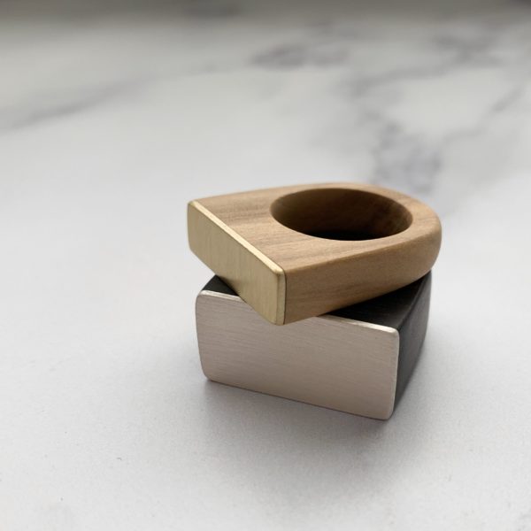 Vannucchi Jewellery's Cally olive wood and brass square topped ring on top of the Whitney silver and ebony square topped ring