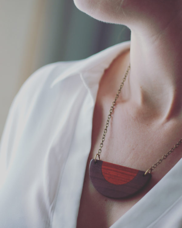Model wears Vannucchi's Belle, brown and red wood semi circular necklace