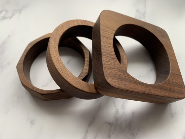 Three walnut bangles of different shapes created by Vannucchi Jewellery