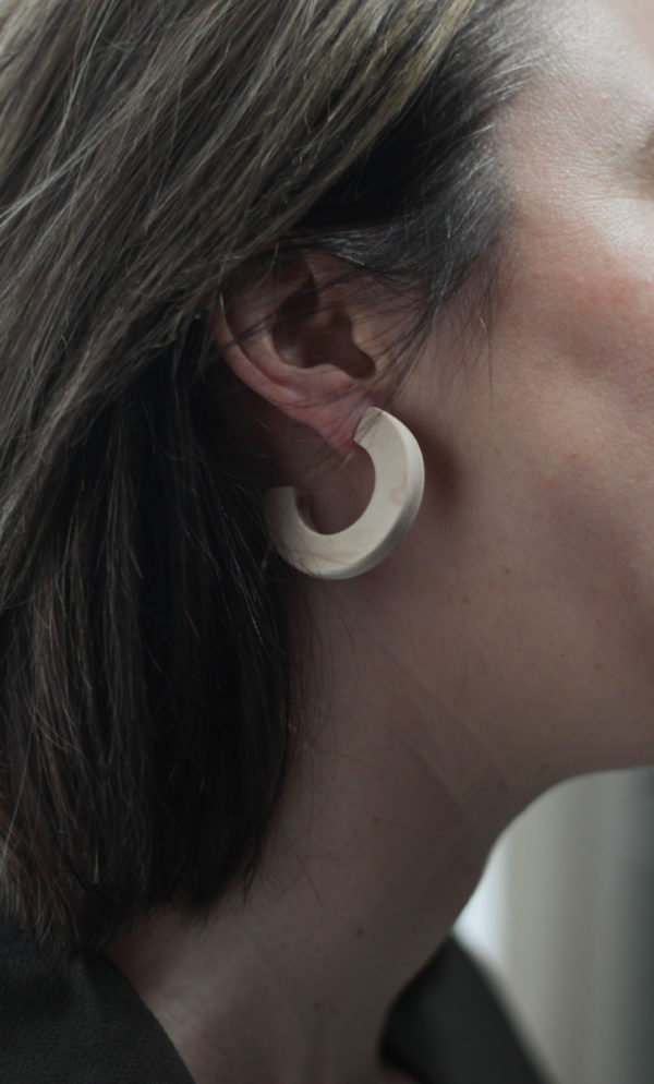Close up of Vannucchi's Claire, maple wood, thick hoop earring