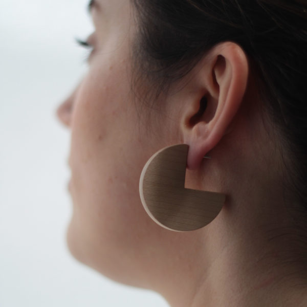 Model wears maple wood, sector shaped, Ellie earrings made by Vannucchi Jewellery