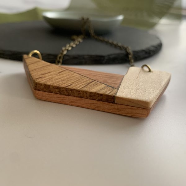 Grandis wood geometric necklace at angle to show layers of wood, created by Vannucchi Jewellery