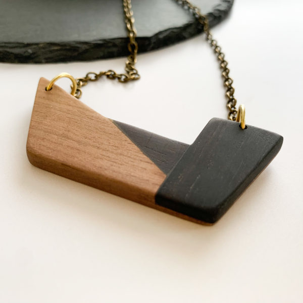 Vannucchi Jewellery Chiaro wood geometric necklace at angle draped over slate