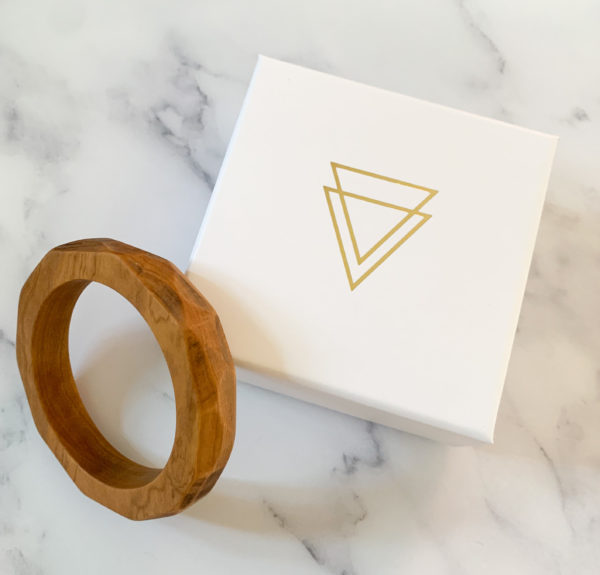 Vannucchi Jewellery's Ruthie multi angled olive wood bangle displayed with branded box