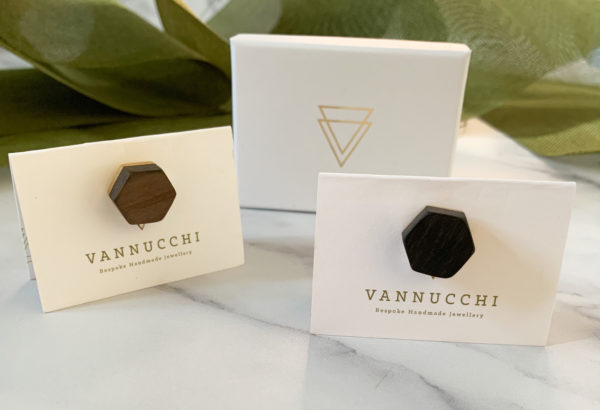 Two wood and brass hex pins on Vannucchi Jewellery display cards