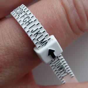 Ring sizing gauge being shown on finger