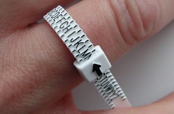 Ring sizing gauge being shown on finger