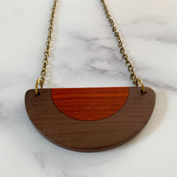 Front facing Belle, brown and red wood semi circular necklace