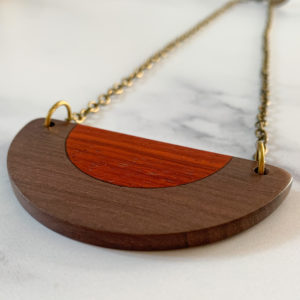 Close up of Belle, brown and red semi circular necklace