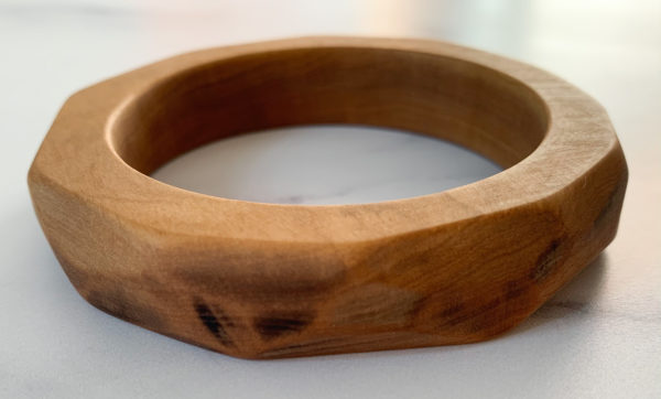 Close up of angles on Vannucchi Jewellery's Ruthie olive wood bangle, front facing