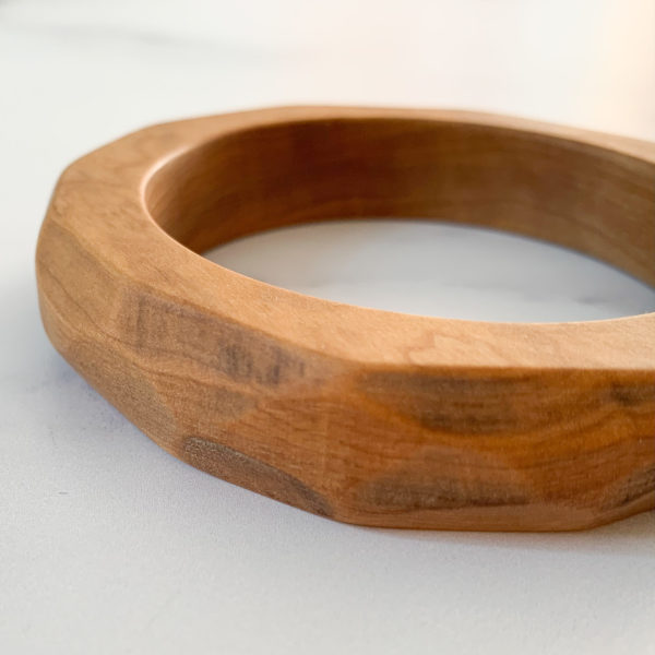 Close up of angles on Vannucchi Jewellery's Ruthie olive wood bangle, left edge