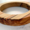 Close up shot of red colours running through Sara parana pine wood bangle created by Vannucchi Jewellery
