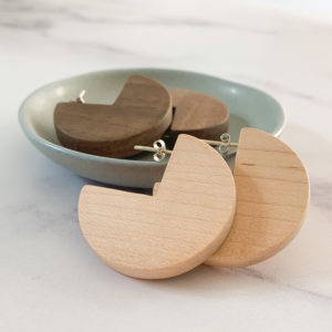 Vannucchi Jewellery, Ellie, sector shaped earrings in walnut and maple, displayed with aqua coloured dish