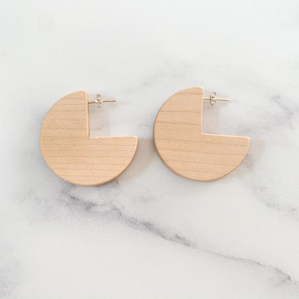 Flat lay of maple wood, sector shaped, Vannucchi Jewellery Ellie earrings