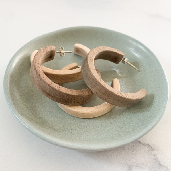 Vannucchi Jewellery, Sarah, wooden hoop earrings in walnut and maple, displayed in aqua coloured dish
