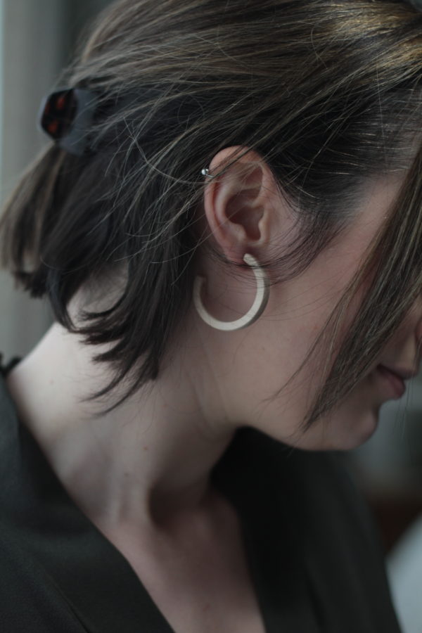 Vannucchi model wears maple Sarah earrings in profile shot