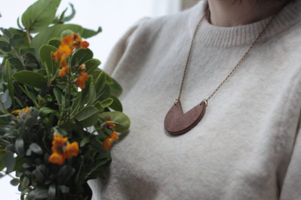 Vannucchi model wears Fiona wood laminate, sector shaped necklace