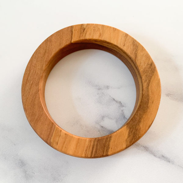 Birds eye view of Vannucchi Jewellery's Ruth round olive wood bangle