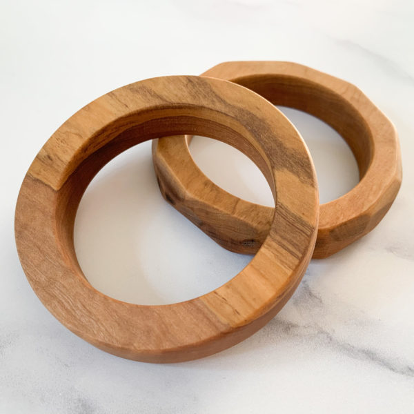 Two Vannucchi Jewellery olive wood bangles, displayed layered