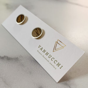 Single pair of Vannucchi Jewellery Suzi silver and oak studs, displayed with packaging