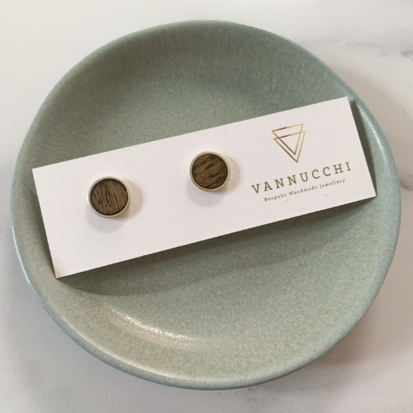 Single pair of Vannucchi Jewellery Suzi silver and oak studs, on aqua coloured dish