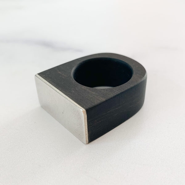Square top, black, ebony wood ring with Silver metal top, angled to the left