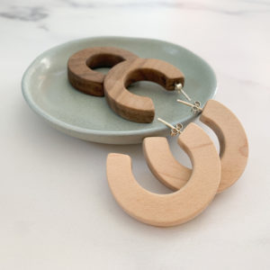 Vannucchi Jewellery, Claire, thick hooped earrings in walnut and maple, displayed with aqua coloured dish