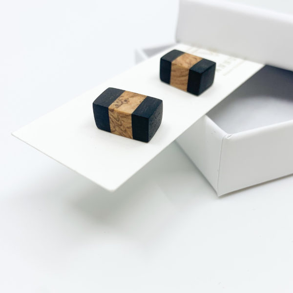 Mixed black wood and olive striped rectangular stud earrings displayed with white packaging on white background