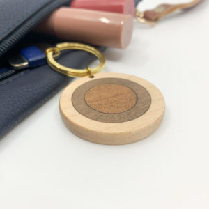 Round mixed coloured wood keyring attached to key in purse