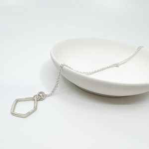 Collezione XXI Large Stone Necklace displayed over a white dish on a white background.