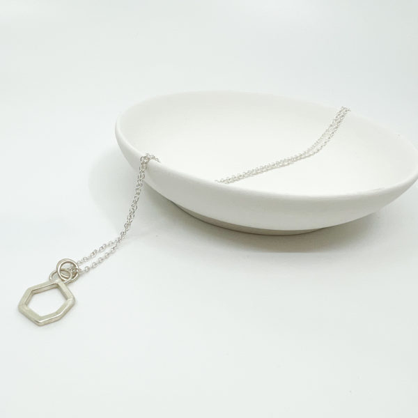 Collezione XXI Stone Necklace is displayed on a white background, laid over a white dish.