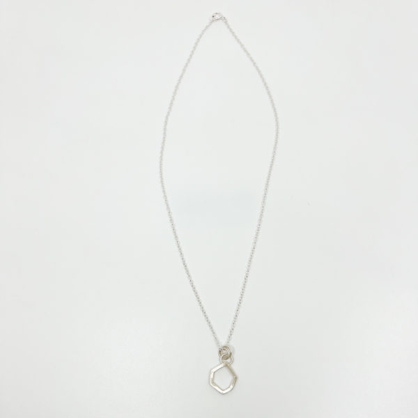 Collezione XXI Stone Necklace is displayed on a white background. Can see full length of necklace. Fine silver chain, with a small square wire irregular geometric shaped pendant.