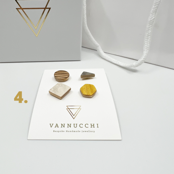 Mix and Match Veneer Pin Set four, with four geometric shaped wood pins, with yellow, grey, white and light brown stripe veneers. Displayed on white Vannucchi backing card.