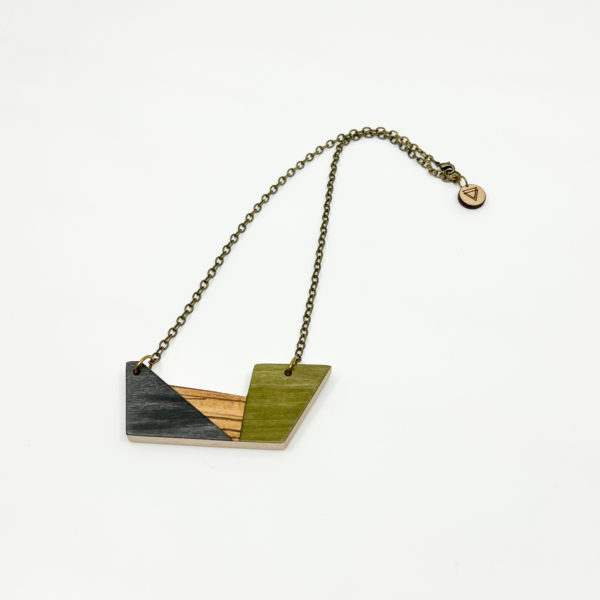The 'Verde' wood geometric necklace on plain white background. Birds Eye View. Colours of necklace are green, black and stripey brown wood veneer.