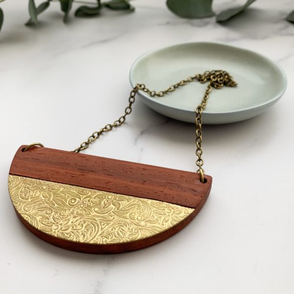 beautiful red wood padauk with a floral brass inlay necklace.