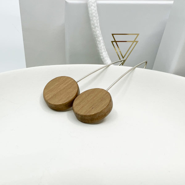 Walnut and silver Rebecca earrings displayed on white dish with Vannucchi branded box in background