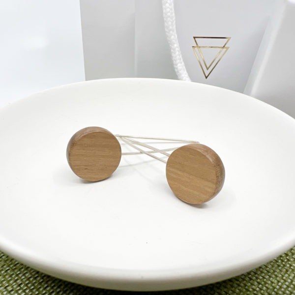 Rebecca Earrings displayed in a white dish, lying criss crossed.