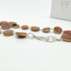 Collezione XXIII Rossa Necklace on white background with branded packaging. Close up of silver clasp.