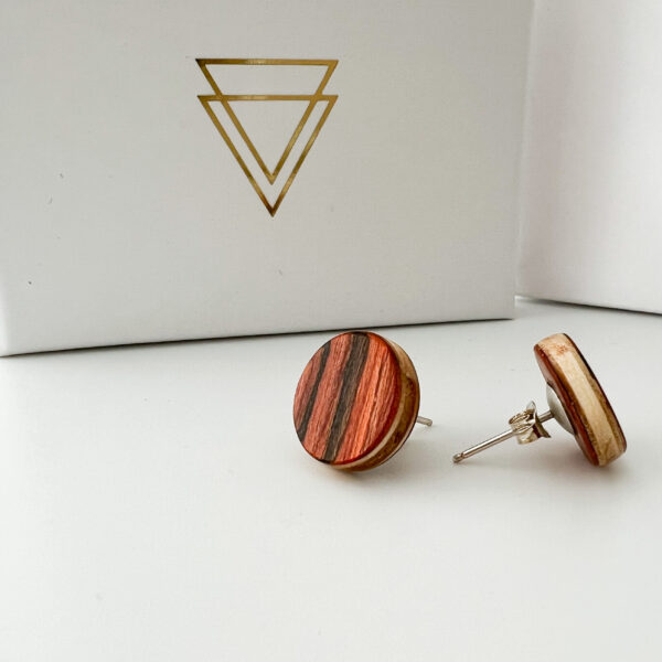 Collezione XXIII Rossa Studs non-white background with branded packaging.